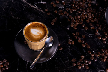 cup of coffee with beans on black background