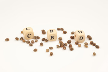 Hemp seeds on white background with alphabet cubes CBD