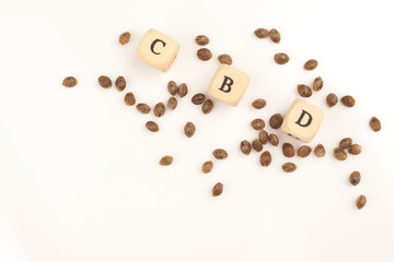 Hemp seeds on white background with alphabet cubes CBD