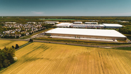 Rural Suburban Farm Land with Woods and Giant Warehouse Aerial Drone View