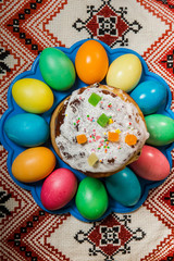 top view of decorated easter bread and dyed easter eggs