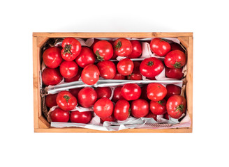 wooden box with red tomatoes on white background