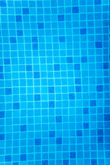 A fragment of blue pool tile, slightly distorted by invisible water