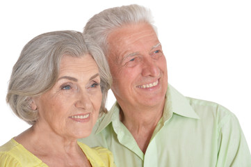 Happy senior couple posing on white background