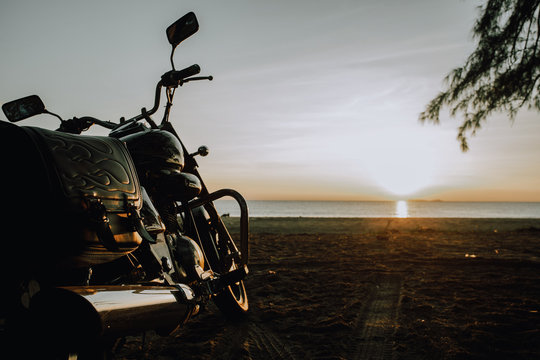 Motorbike Parked On The Beach At The Sunrise.