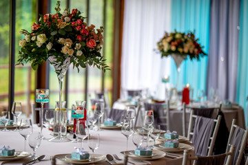 Bouquet of flowers and glasses on the wedding table