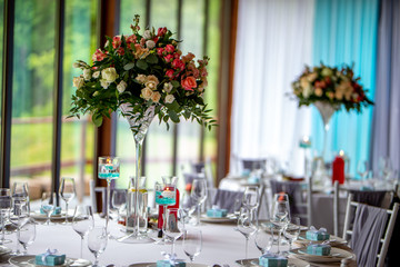 Bouquet of flowers and glasses on the wedding table