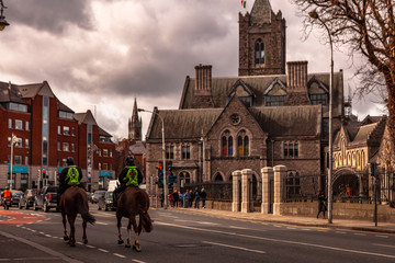 Dublin, Ireland – March 2019. Policeman on crowd control horses near to Christ Church Cathedral...