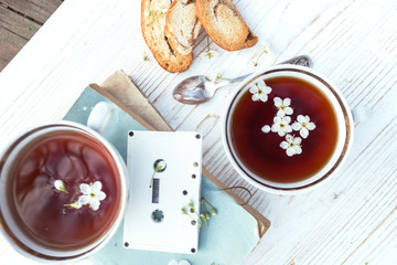 still life - cups of tea, crackers, books and cassette