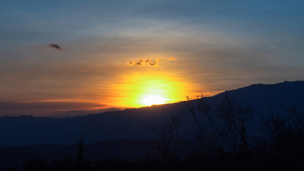 Obraz premium The sun starts to hide behind the Andean mountains of central Colombia.
