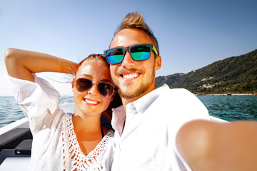Two young people on summer boat and ocean landscape 