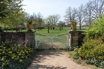 Old locked white wooden gate in the park