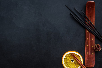 incense sticks with citrus for fresh air on dark background top view mock up