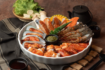 Close up raw seafood, fish, mussels, oyster, mushroom and meat in a set preparing for serve in a restaurant