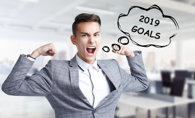 Business, technology, internet and networking concept. Young entrepreneur shouts out a keyword: 2019 goals