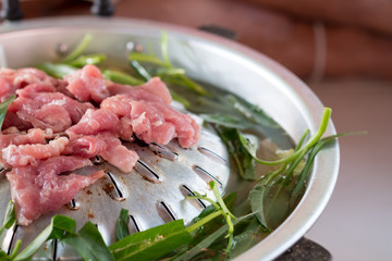 Grilled pork on pan hot pot in soup with morning glory