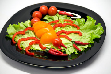 vegetables on a plate laid out in the shape of a scorpion	