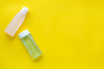 Organic cosmetics for face clearing with facial tonic and mycelial water on yellow background top view copy space