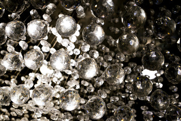 Glass Balls Hanging on Strings With Light From the Back