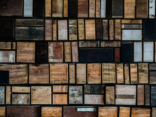 Geometric wooden vintage background made of wooden bars of various shapes and different colors. Rough Geometric Wooden Background