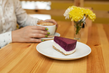 Woman dinner with cheessecake and coffee at restaurant