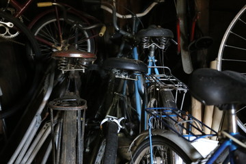 Fototapeta na wymiar old bicycles and tools in the garage, shed