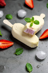 Strawberry ice cream stick covered with white chocolate