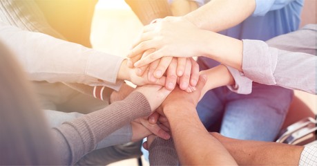 Group of people stacking hands together