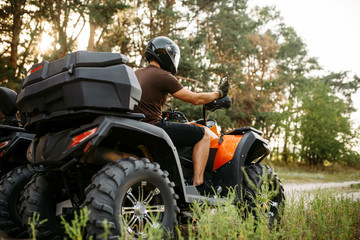 Rider in helmet on quad bike, front view, closeup © Nomad_Soul