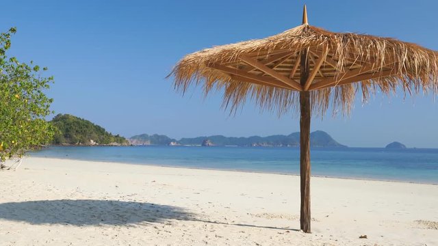leaf umbrella on tropical white sand beach, Nyaung Oo Phee, Myanmar, Lockdown.