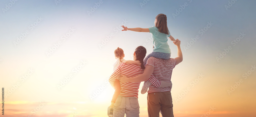 Wall mural happy family at sunset.