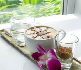 Close up glass of hot coffee with green nature background