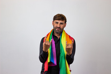 Portrait of handsome young man with gay pride movement LGBT Rainbow flag and brown hair vulnerable, looking at the camera. Isolated on white background.