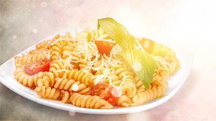 A baked dish of fusilli or pasta spirals, with cherry tomatoes, ricotta and parmesan