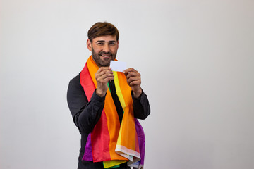 Portrait of handsome young man with gay pride movement LGBT Rainbow flag and brown hair giving a handshake, their back facing the camera and looking at the camera. Isolated on white background.