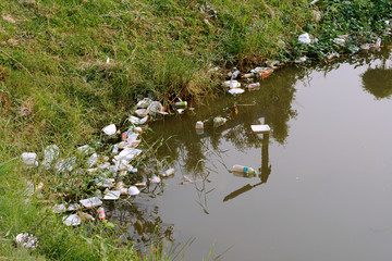 Plastic garbage in the river , pollution and environment in the water.