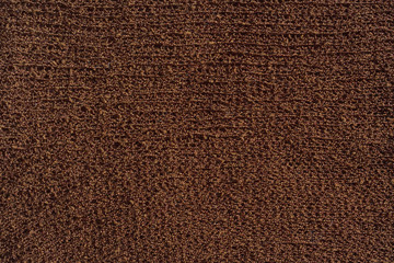 Brown knitted fabric texture. Knitted abstract background chocolate color. Dark brown fabric.
