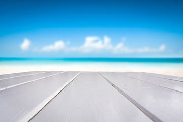 Desk of free space and summer beach background. 