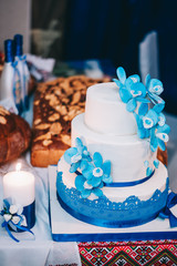 wedding cake with flowers yellow beige red turquoise blue