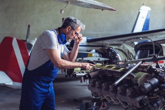 Senior Engineer Repairing Aircraft Engine 