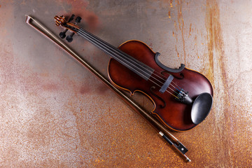 Obraz na płótnie Canvas Classical violin on rusty background. Studio shot of old violin. Classical musical instrument
