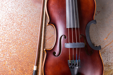 Classical violin on rusty background. Studio shot of old violin. Classical musical instrument