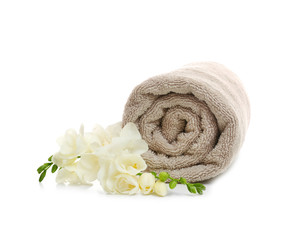 Clean rolled towel with flowers on white background