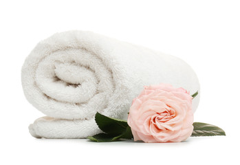 Obraz na płótnie Canvas Clean rolled towel with flower on white background