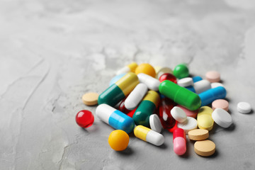 Heap of different pills on table, closeup. Space for text