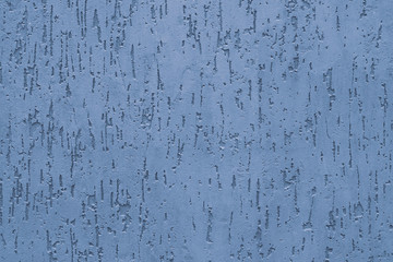 Blue stucco with embossed backdrop on concrete wall. Abstract soft blue pattern on the ribbed wall. Painted blue textured surface, pastel background of relief.