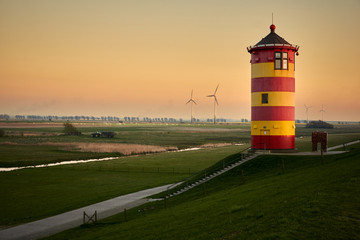 Pilsum lighthouse at sunset on the East Frisian coast in Germany