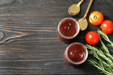 Flat lay composition with barbecue sauce, rosemary and tomatoes on wooden background. Space for text