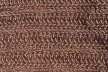 Brown texture knitted wool fabric. Cappuccino knitted abstract background. Light brown wool for knitting.