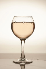 Wine glass with wine (water) on a gradient background